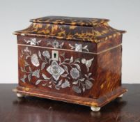 An early Victorian tortoiseshell and floral mother of pearl inlaid two division tea caddy, on turned