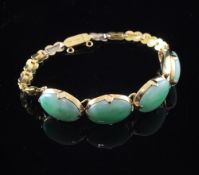 A Chinese gold and jade bracelet, with engraved links and set with four cabochon jade stones,