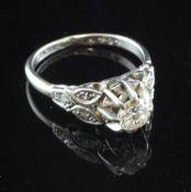 An 18ct white gold and platinum single stone diamond ring, with diamond set shoulders and raised