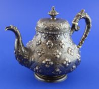 A Victorian silver teapot by Robert Hennell II, of squat baluster form, embossed with flowerhead
