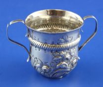 An early George III silver porringer, with banded girdle, engraved inscription and embossed with
