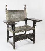 A 19th century Spanish carved oak armchair, with embossed leather back and seats, with fancy brass