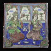 A Persian Qajar dynasty moulded polychrome pottery tile, decorated under the glaze with an