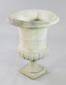 A late 19th century carved campana shaped urn, with half gadrooned body, on square plinth base, H.