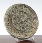 A Chinese bronze 'grapevine' circular mirror, Tang Dynasty, cast in relief with tree shrews amid