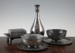 A collection of 19th century Indian Bidriware items, including a bottle shape vase, a rectangular