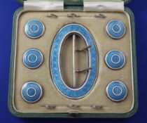 A cased Edwardian seven piece silver and guilloche enamel buckle and button set, comprising oval