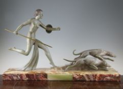 A French Art Deco patinated metal model of Diana the huntress, with two dogs, on a rectangular