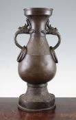 A large Chinese bronze hu vase, Yuan Dynasty, of archaistic form, the flattened pear shape body