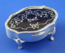 A George V silver and tortoiseshell pique trinket box, of shaped oval form, of four cabriole feet,