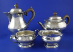 A George V silver four piece tea set, of squat circular form, with gadrooned borders, Z. Barraclough
