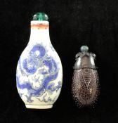 A Chinese amethyst crystal snuff bottle and a Chinese enamelled porcelain 'dragon' snuff bottle, the
