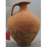 A Roman terracotta flagon, c.2nd century AD, of ovoid form with saturn disc neck and looped