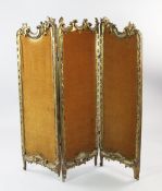 A low Louis XV style carved giltwood three fold screen, with C scrolls and acanthus leaf decoration,