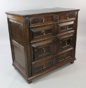 A late 17th century oak chest, of four long drawers with geometric fronts, on stile feet, W.3ft