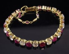 A Middle Eastern high carat gold, ruby and white topaz bracelet, set with twenty five alternating