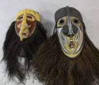 Two Papua New Guinea Sepik River carved wooden ceremonial masks, each with integral handle,