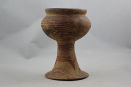 A Bam Chiang pottery goblet,Thailand 4th century AD, with typical cream and red slip stylised