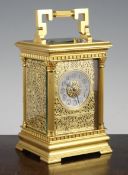 An Edwardian ormolu hour repeating carriage clock, with gilt fret work dial, silvered arabic chapter