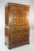 An 18th century walnut and featherbanded chest on chest, with reeded canted sides, fitted three