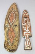 A Papua New Guinea Sepik River carved wooden gope board, polychrome decorated with a stylised
