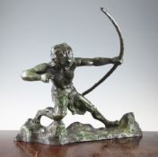 A Continental Art Deco green patinated bronze model of a male archer, on a rocky base,