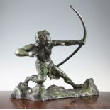 A Continental Art Deco green patinated bronze model of a male archer, on a rocky base,