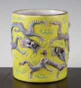A Chinese yellow ground 'dragon' brush pot, Guangxu mark, early 20th century, modelled in relief