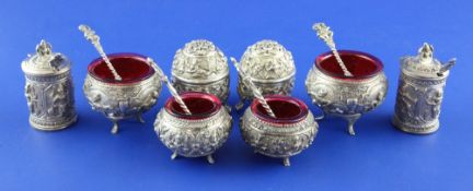 Eight early 20th century Indian silver condiments, comprising two pairs of salts with liners, a pair