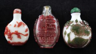 Three Chinese overlaid glass snuff bottles, 1850-1940, the first in pink and green overlay on a