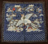 A Chinese Kesi rank badge, 19th century, decorated with a white bird amid clouds and emblems of