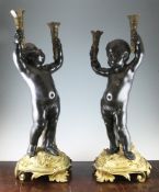 A pair of late 19th / early 20th century French bronze and ormolu torcheres, each modelled as a