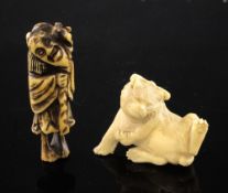 A Japanese ivory figure of a cat and a stag horn netsuke, the cat with a tied bow to its head,