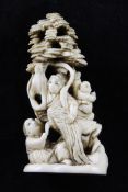 A Japanese ivory okimono netsuke, early 20th century, carved with a female immortal and other