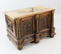 A 19th century Swiss coffer, the lid with sprung lock, the front with two arched panels carved