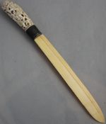 An early 20th century Indonesian ivory and silver mounted paperknife, with carved and pierced