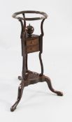 A George III mahogany wig stand, with circular top, powder box and two fitted drawers, on