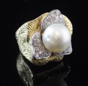 A large textured gold, baroque pearl and diamond set dress ring, with an estimated total diamond