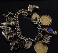 A 9ct gold curb link charm bracelet, hung with eleven assorted charms including an 1887 gold full