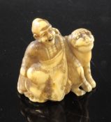 A Japanese walrus ivory netsuke of Binzuru Rakan and a tiger, Meiji period, each seated before