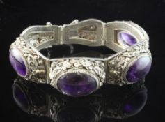 A 20th century Chinese silver filligree and cabochon amethyst bracelet, set with four oval stones.