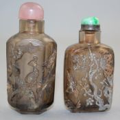 Two Chinese cameo quartz snuff bottles, 1800-1870, each carved in relief to the upper pale grey