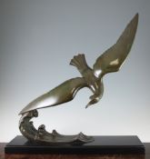 L. Alliot. A French Art Deco patinated bronze model of a sea bird on the crest of a wave, on a