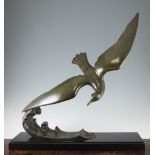 L. Alliot. A French Art Deco patinated bronze model of a sea bird on the crest of a wave, on a