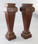 A pair of painted cast iron Adams style pedestals, with square tops, on tapering central square