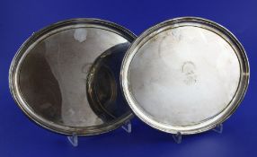 A pair of 19th century Sheffield plate oval waiters, with engraved armorial and monogram, on four