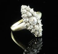 A late Victorian 18ct gold and marquise shaped diamond cluster ring, with reeded shoulders and set