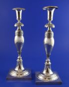 A pair of early 19th century German silver candlesticks, with waisted stems and embossed with
