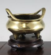 A Chinese bronze tripod censer, six character Xuande mark, 19th century, with high looped handles,