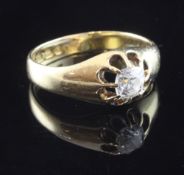 An early 20th century 18ct gold and claw set solitaire diamond ring, with cushion cut diamond,